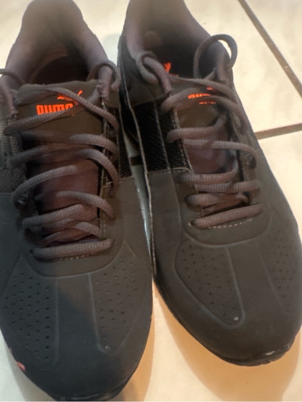 PUMA women’s Black Athletic Sneakers with Orange Accent